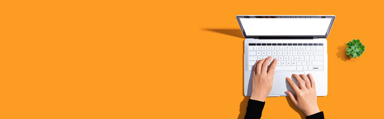 Person using a laptop computer from above