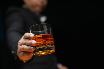 Closeup businessmen holding a glass of whiskey