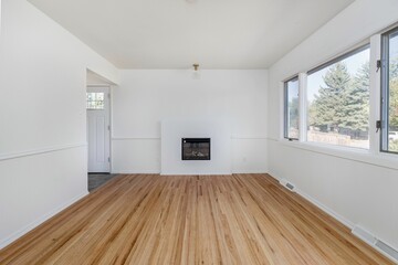 Fototapeta premium Interior view of an empty room with wooden parquet flooring and white walls with big glass window