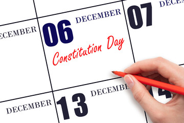 December 6. Hand writing text Constitution Day on calendar date. Save the date.