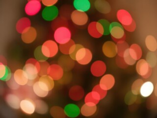 Fototapeta premium Blurred Christmas lights creating a bokeh effect in red, green, and white hues, background