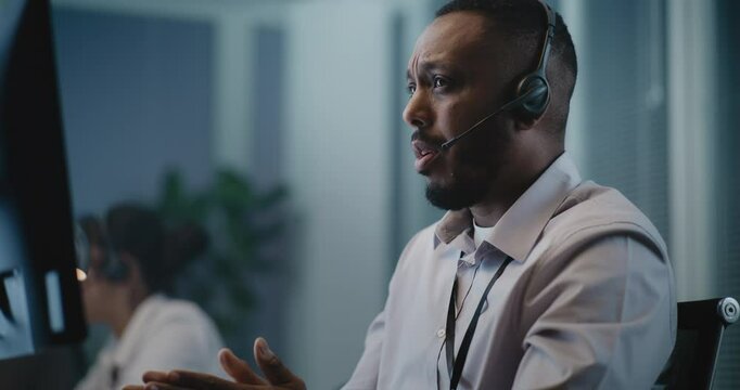 Psychological hotline call center: Close up of African American crisis helpline counselor in headset talking to person during online call, providing mental health support. Suicide prevention service.