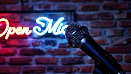 Microphone pointing at open mic neon sign