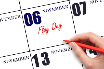 November 6. Hand writing text Flag Day on calendar date. Save the date.