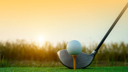 Golf clubs and balls on a green lawn in a beautiful golf course with morning sunshine.