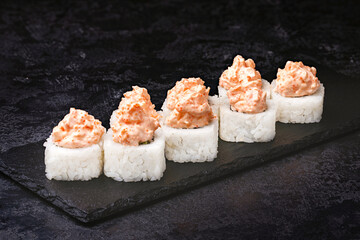 Japanese rolls, sushi on a black background.