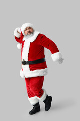 Dancing Santa Claus on grey background