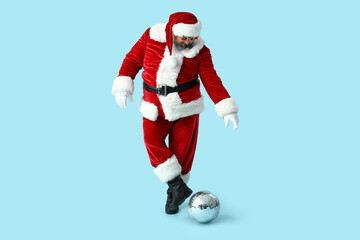 Funny Santa Claus with disco ball dancing on blue background