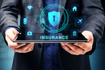 Digital insurance concept with holographic icons displayed on a tablet screen.