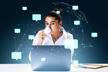 Businesswoman working on a laptop with floating speech bubbles representing social network connections.