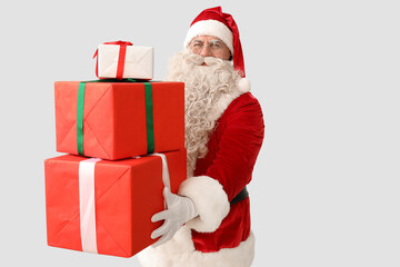 Santa Claus with Christmas gifts on white background