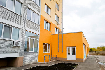 A new multi-storey brick residential building with an attached space for a store.