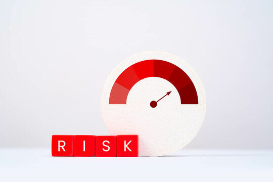 A visual representation of risk measurement, featuring a gauge and blocks spelling 'RISK' against a minimalist background.