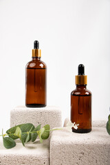 Amber Dropper Bottle on Textured Stone with Greenery for Natural Skincare and Wellness