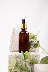 Amber Dropper Bottle on Textured Stone with Greenery for Natural Skincare and Wellness