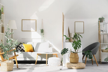 Interior of office with workplace, folding screen and sofa