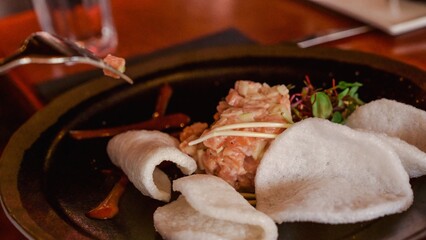 Indulge in the Exquisite Culinary Experience of Salmon Tartare with Crispy Wonton Chips