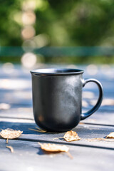 Cup of hot drink on nature background. Morning in the forest in nature with a hot drink