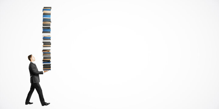 Businessman carrying an extremely tall stack of books on a white background.