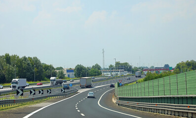 multiple highways converging into a larger one with cars speeding on the asphalt