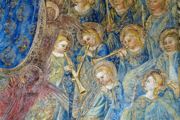 Fresco (15th century) of a group of musician angels in the sky playing music. ...