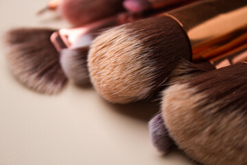 Makeup brushes close-up on beige background