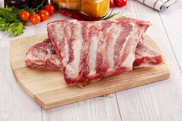 Raw pork ribs over board
