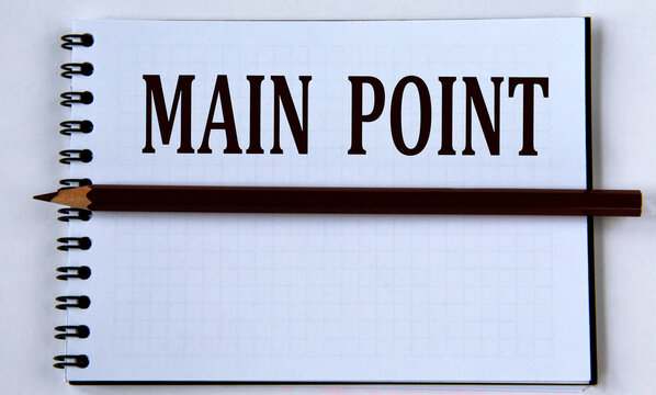 MAIN POINT - words in white notebook on white background with pencil
