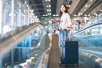 Portrait of standing tourist woman passenger at international airport terminal for holidays travel