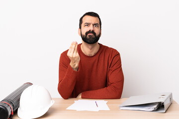 Caucasian architect man with beard in a table making Italian gesture.