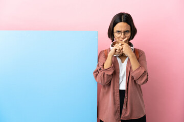 Young student mixed race woman with a big banner over isolated background showing a sign of silence gesture