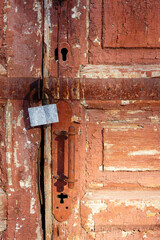 Old traditional wooden door with metal lock close-up. Metal lock for security. Lock on the door