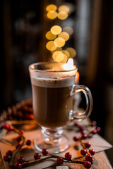 cup of coffee on table with christmas decorations background bokeh