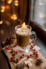 cup of coffee on table with christmas decorations background bokeh