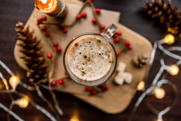 cup of coffee on table with christmas decorations background bokeh top view flatlay
