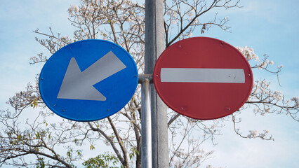 Traffic signs no entry for all vehicles one-way street on a blue sky