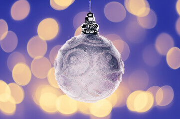 Sparkling white Christmas ornament with intricate details, set against a soft, festive bokeh...