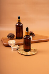 Amber Glass Dropper Bottles with Pinecones and Candle on Wooden Tray for Spa and Aromatherapy Decor