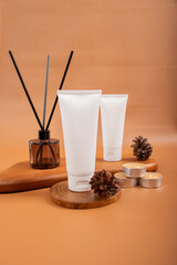 White Cosmetic Tube with Candles and Diffuser on Wooden Tray for Skincare Product Mockup