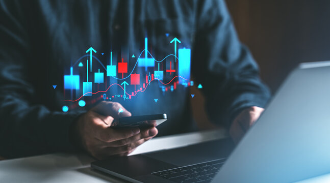 Businessman working with laptop and phone, forex diagrams and rising arrows