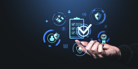 Hand interacting with digital healthcare and insurance icons in a futuristic style on a dark...