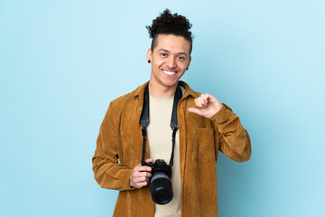 Photographer man over isolated blue background proud and self-satisfied