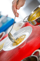 Chef is serving some white beans in a plate