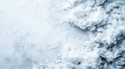 A close-up view of natural salt crystals on a light background, showcasing texture.
