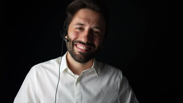 Elegant young Man working for call center looking at the camera and smiling. Kind Customer Service