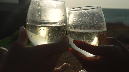 Wine Glasses Toast Celebration - Two people clinking wine glasses in a toast to celebrate an occasion.