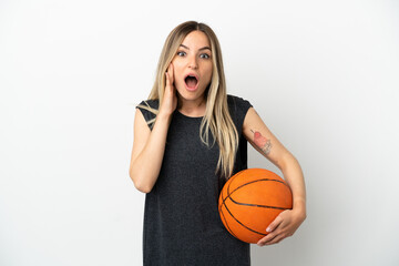 Young woman playing basketball over isolated white wall with surprise and shocked facial expression