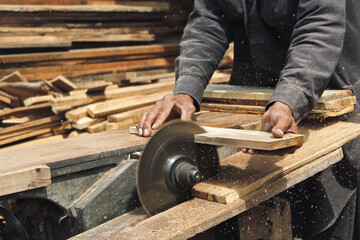 man cutting wood with table saw