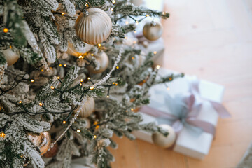 A beautifully decorated Christmas tree with gifts under it during winter