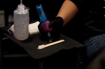 Tattoo Artist Dipping Needle into Ink - Preparing for Tattoo Application